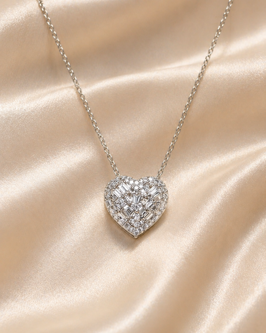 Heart-shaped diamond necklace on a beige satin background
